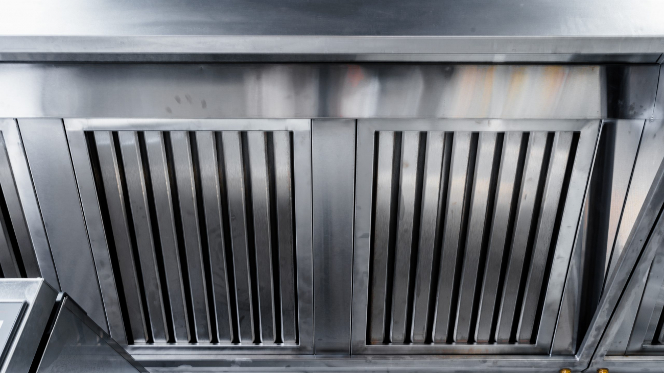 New clean stainless steel hood in professional kitchen close up