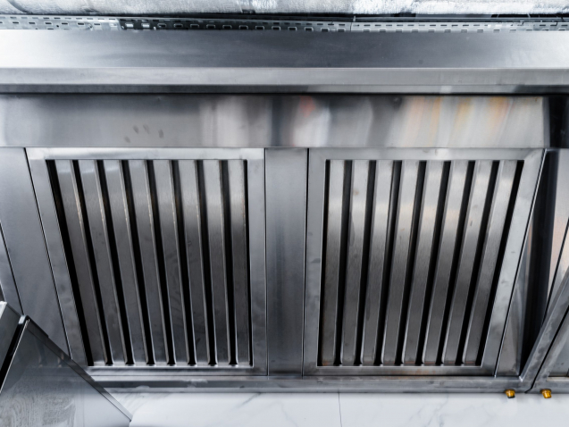 New clean stainless steel hood in professional kitchen close up